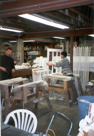 Carter and helper assembling mahogany window sash in the Dock Road basement workshop